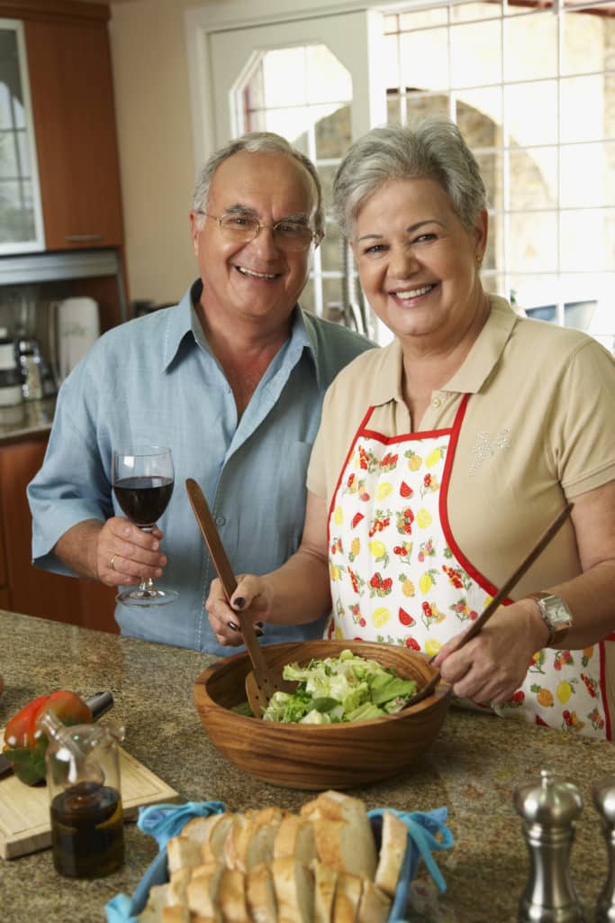 Senior Hispanic couple preparing food