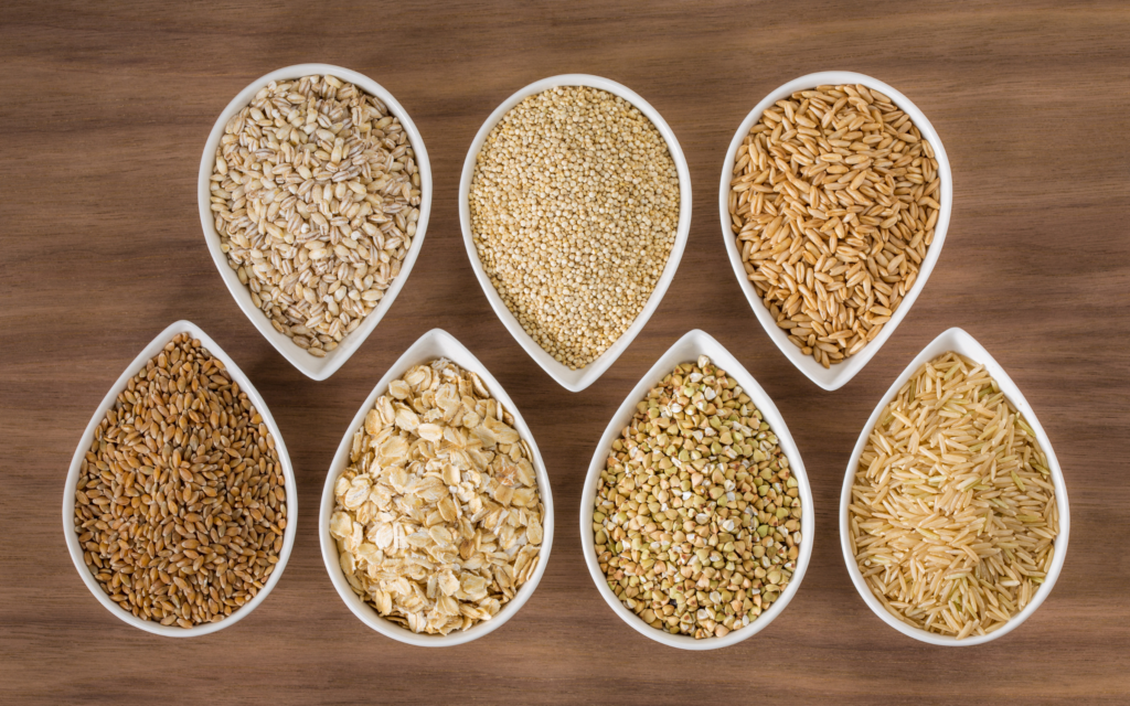 Bowls lined up with various types of grains in each