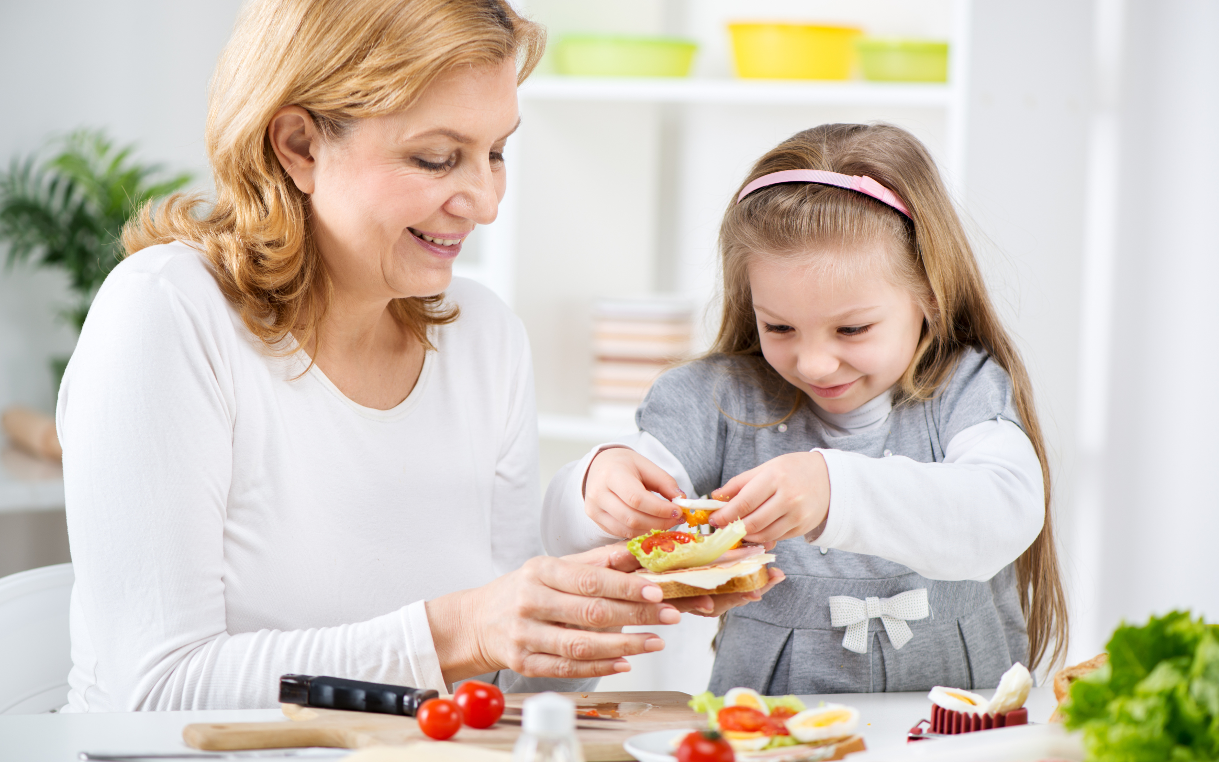 Grandmother and toddler making a sandwich
