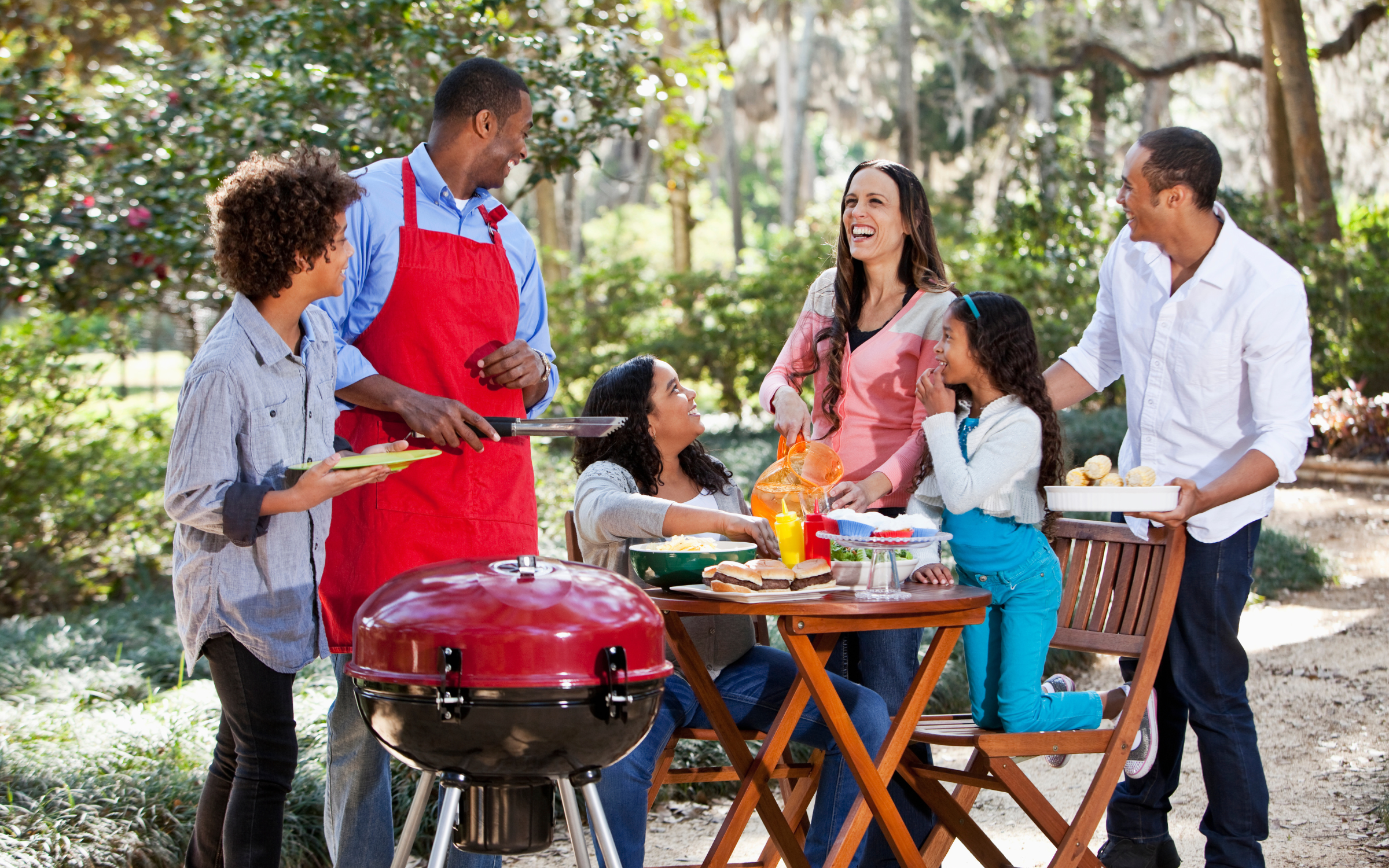Family outside enjoying a BBQ
