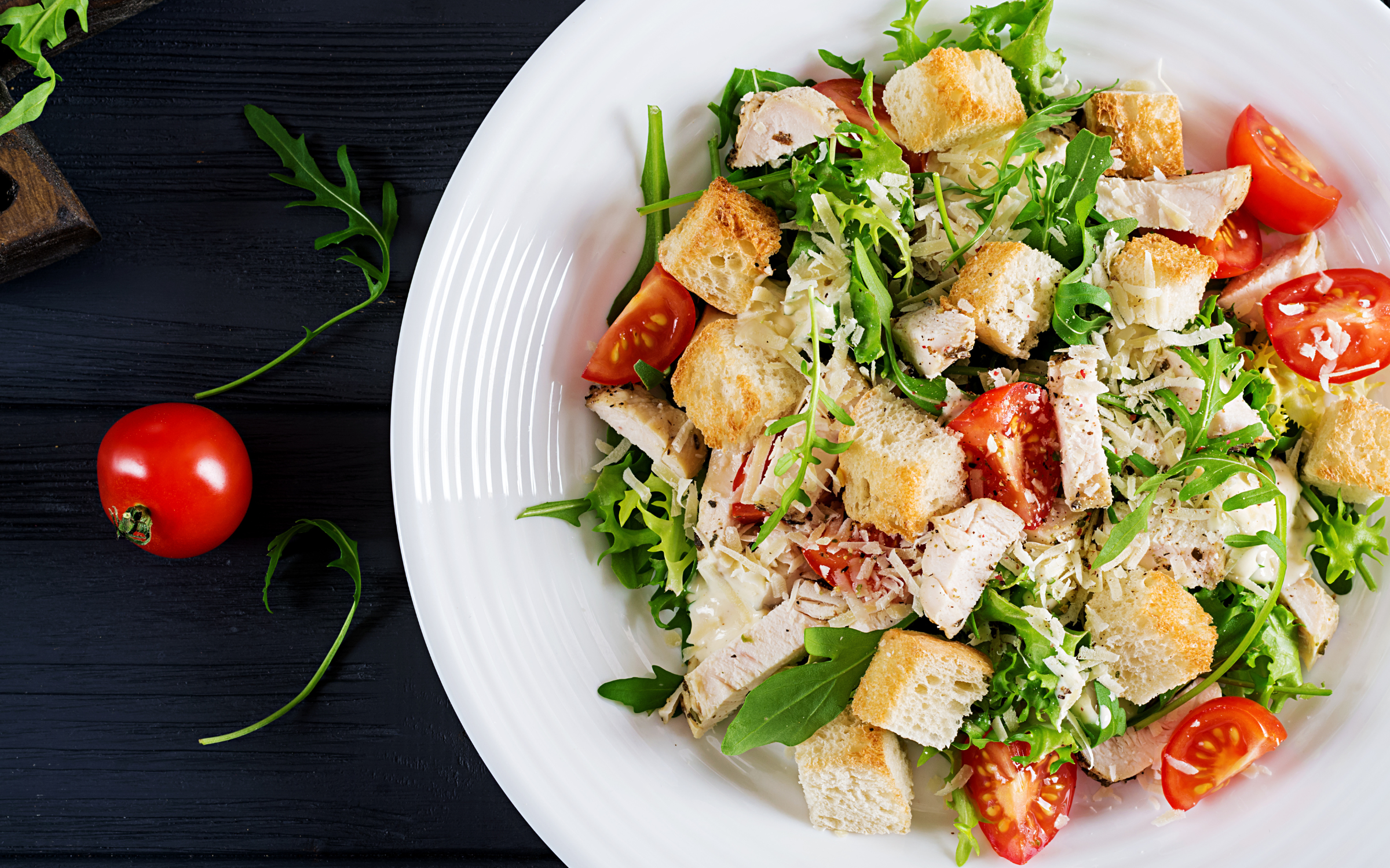 Salad with cherry tomatoes, chicken and croutons