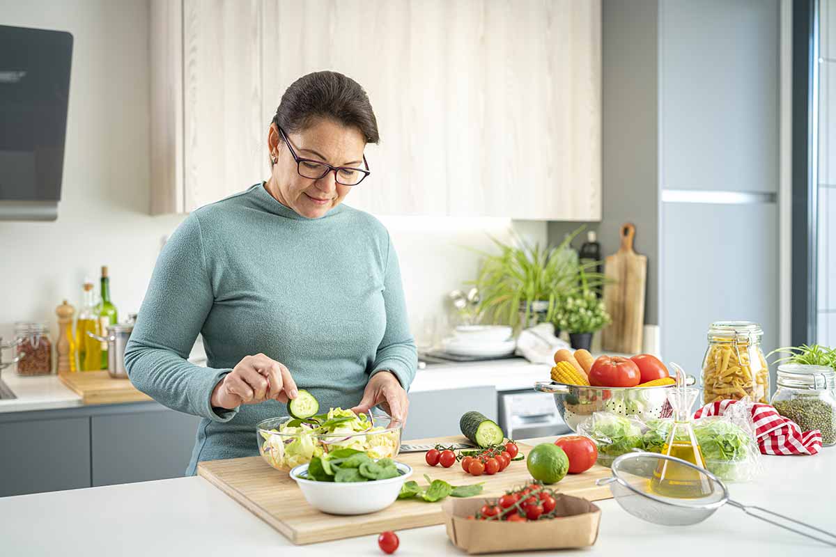 woman making a salad with fresh vegetables